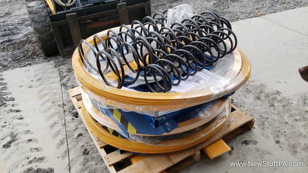 Spring-Actuated Pallet Carousel Skid Positioner